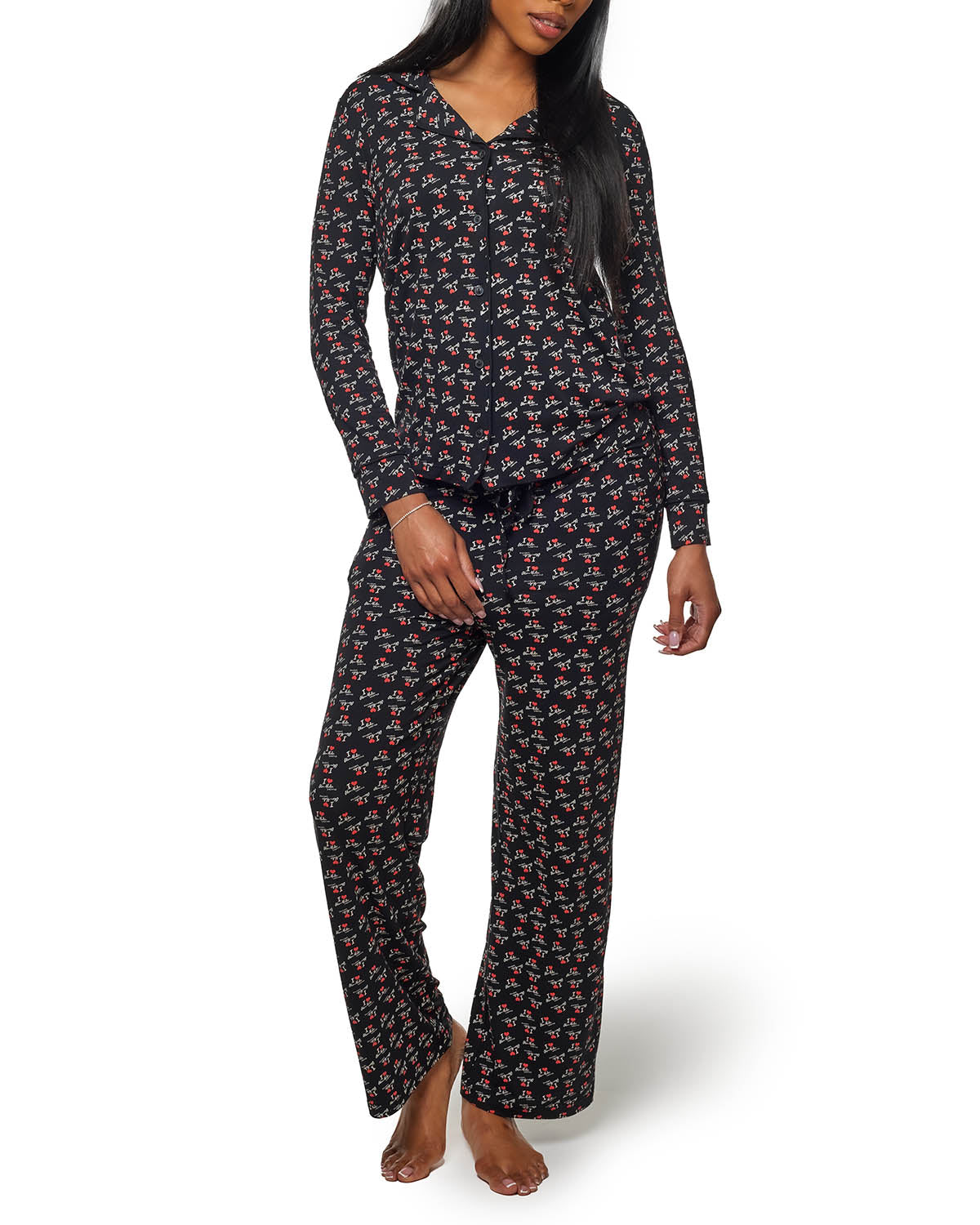 Black pajama set featuring a floral pattern, long sleeves, and relaxed fit for comfortable lounging.