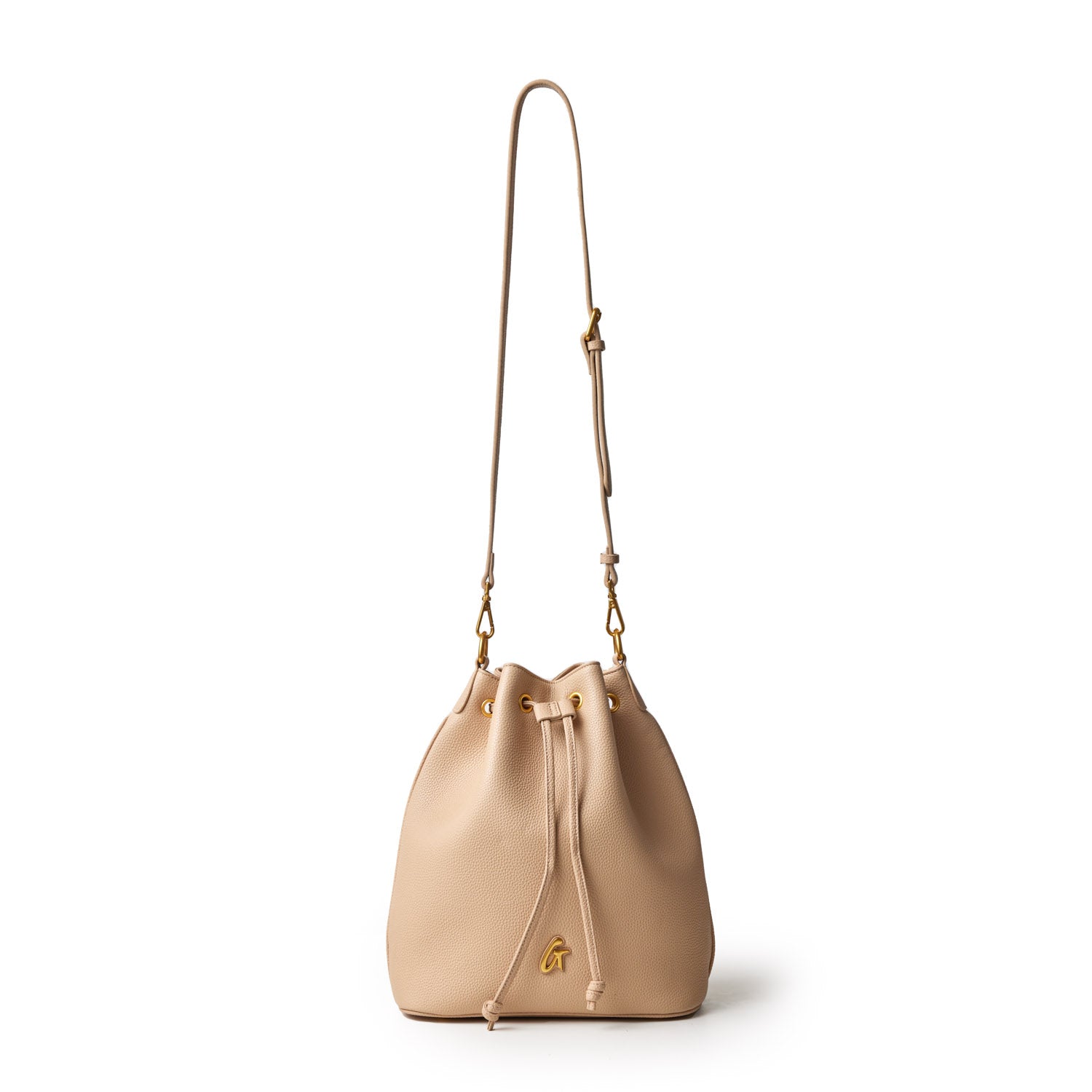 Large nude pebble bucket bag with a drawstring closure, gold hardware, and an adjustable shoulder strap.