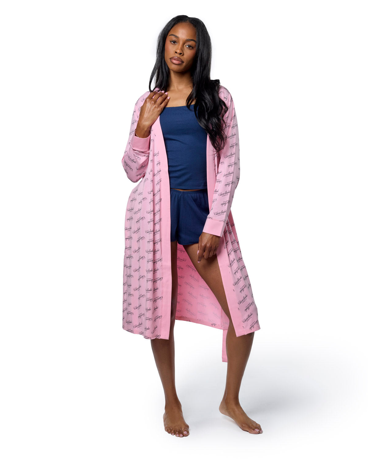 Light pink signature luxe robe featuring a stylish design, worn over a navy top and shorts, ideal for chic lounging.
