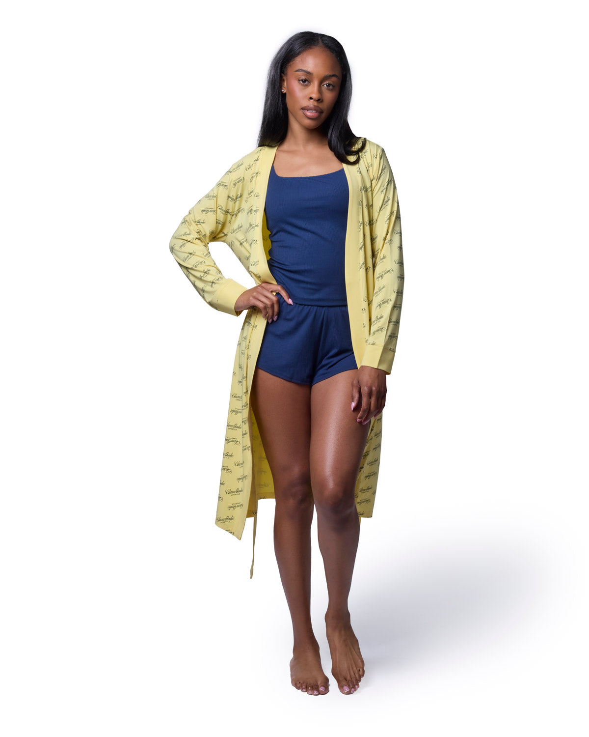 Model wearing a yellow signature luxe robe over a navy outfit, showcasing a stylish and comfortable loungewear look.