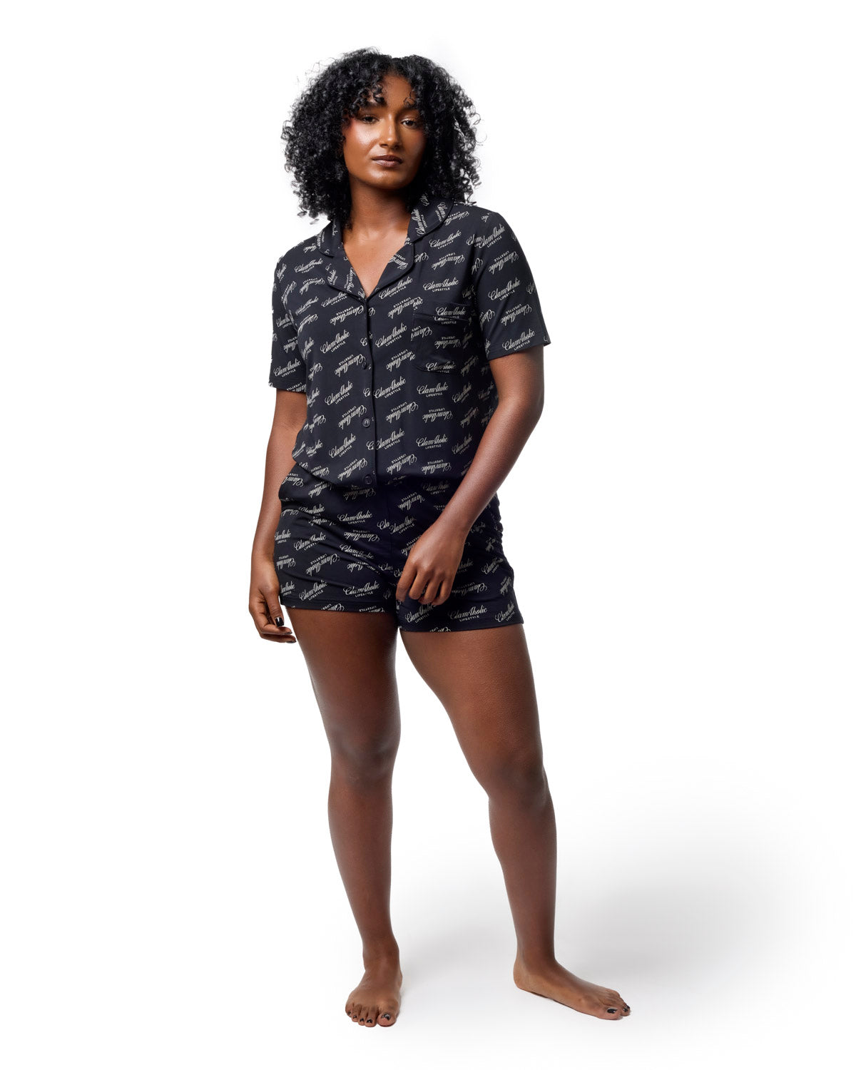 Black pajama short set featuring a stylish print, designed for comfort and luxury in loungewear. Perfect for relaxation.
