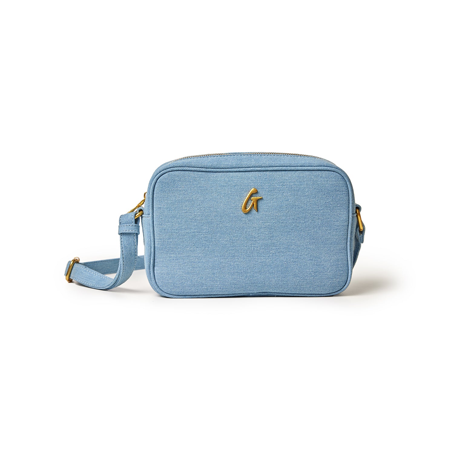 Light blue denim camera bag with gold hardware, adjustable strap, and a front logo, designed for stylish camera carrying.