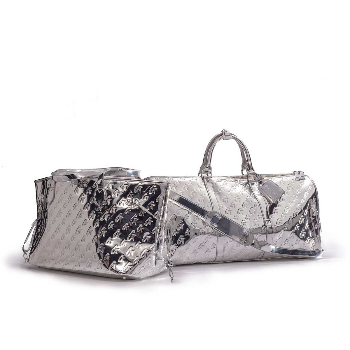 Metallic silver monogram travel set featuring a spacious duffel bag and matching pouch, perfect for stylish travel.