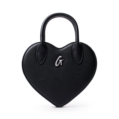 Black heart-shaped bag with top handles and a silver "G" logo on the front, designed for stylish everyday use.