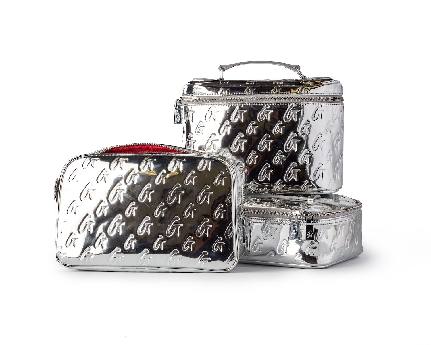Set of small metallic silver monogram toiletry bags with embossed logo pattern, including a zippered pouch and travel case.