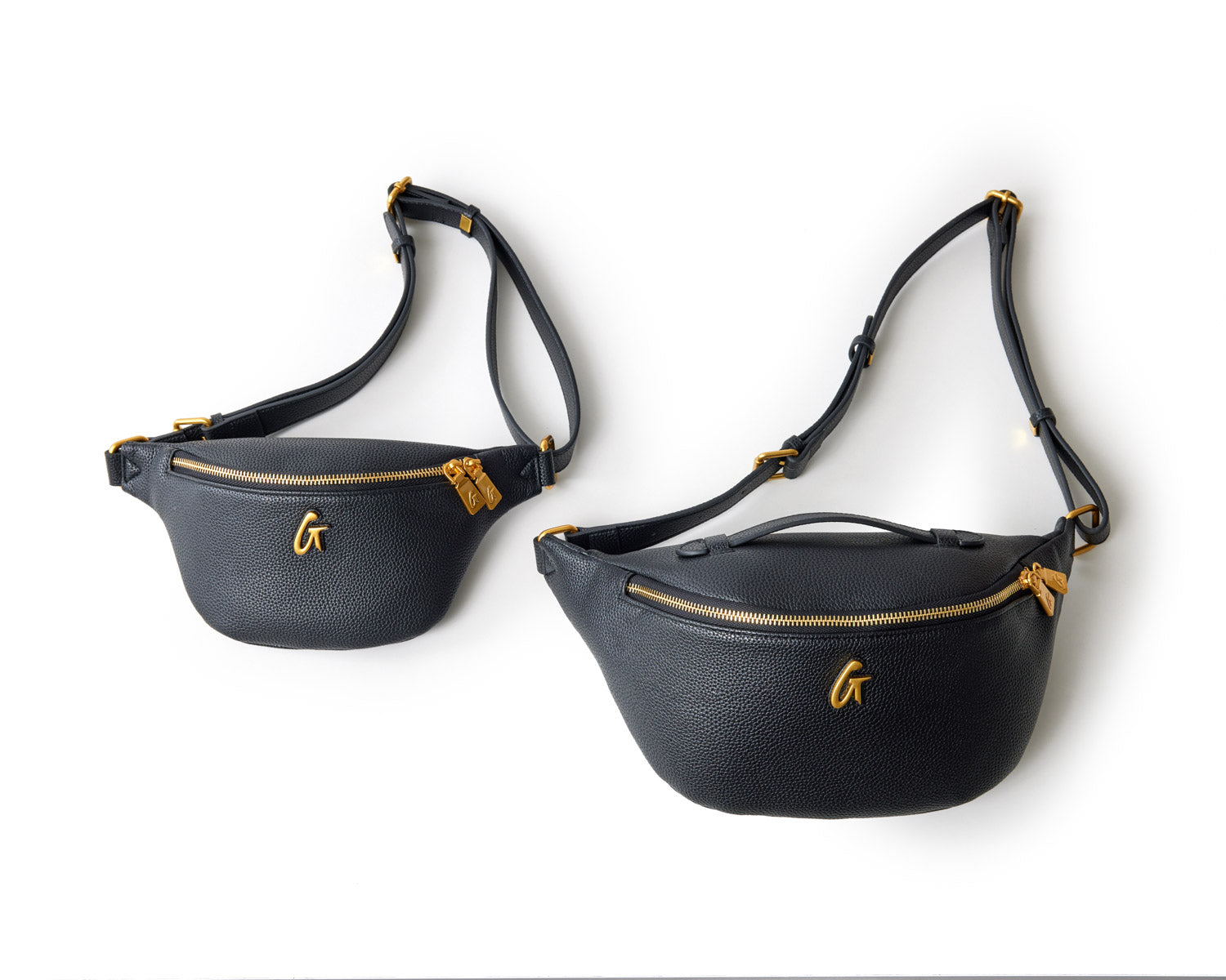 Two black mini pebble fanny packs with gold zippers and hardware, featuring a small gold "G" logo, laid flat on a white background.