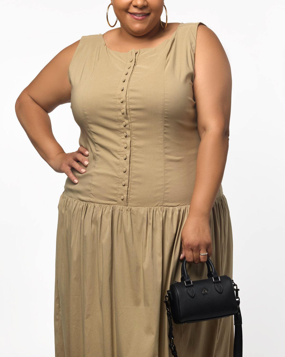 Black NANO STANDARD GAL BOSTON BAG held by a woman in a beige dress, showcasing a chic and stylish accessory.