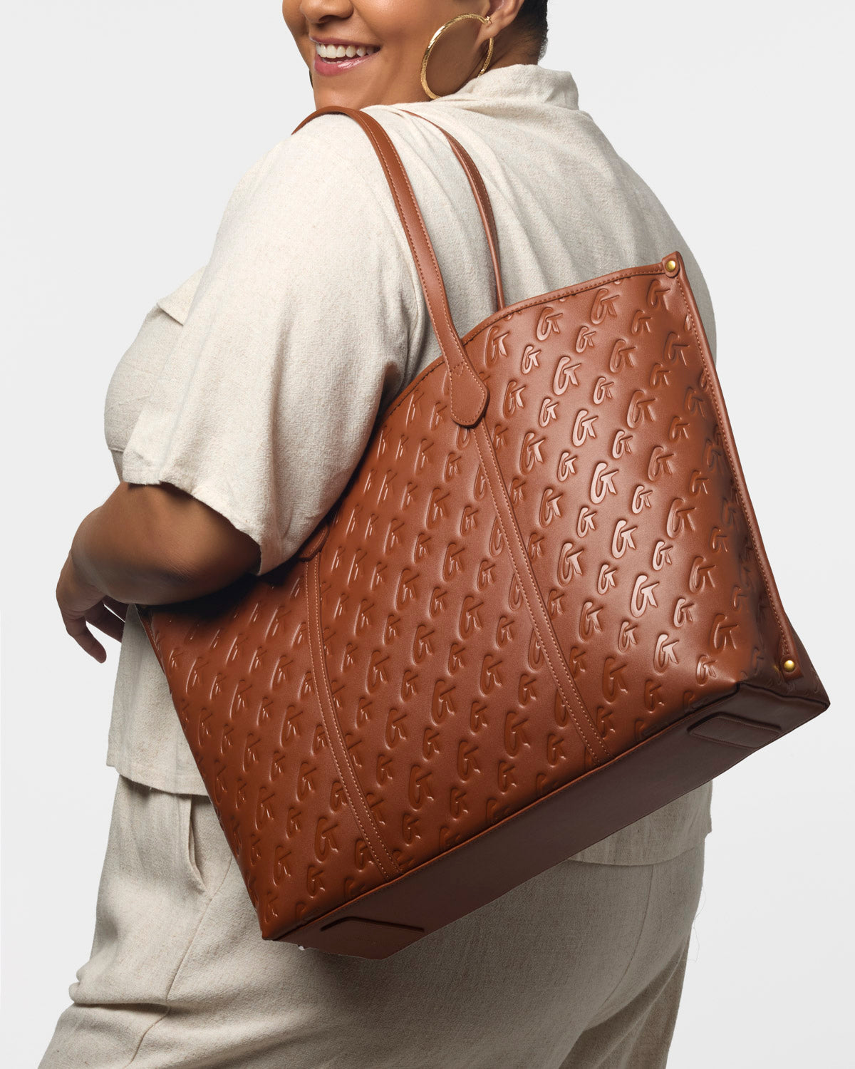XL Monogram Sleek Tote in brown, featuring embossed logo design, spacious interior, and stylish shoulder straps.