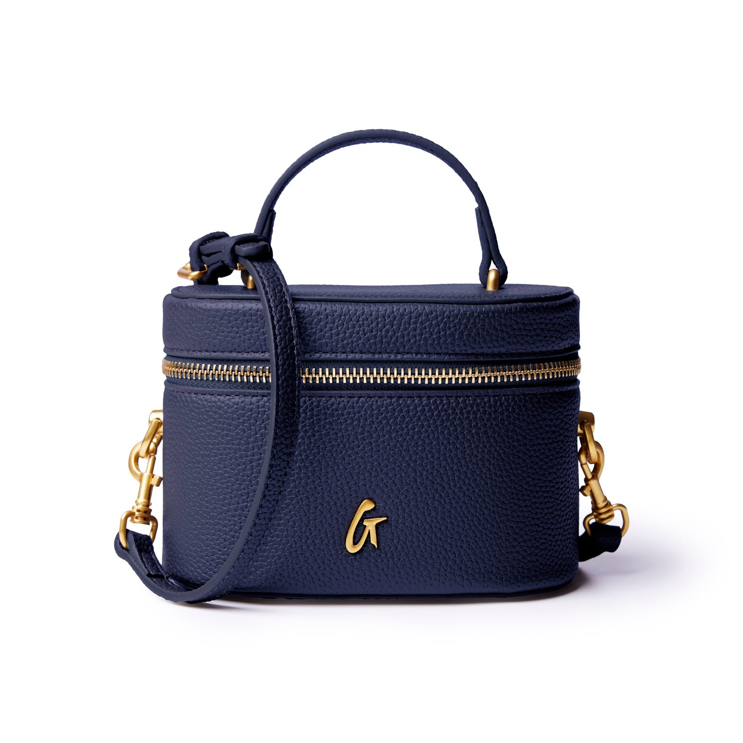 Navy mini pebble vanity bag with gold zipper and logo, featuring a top handle and detachable strap for versatility.