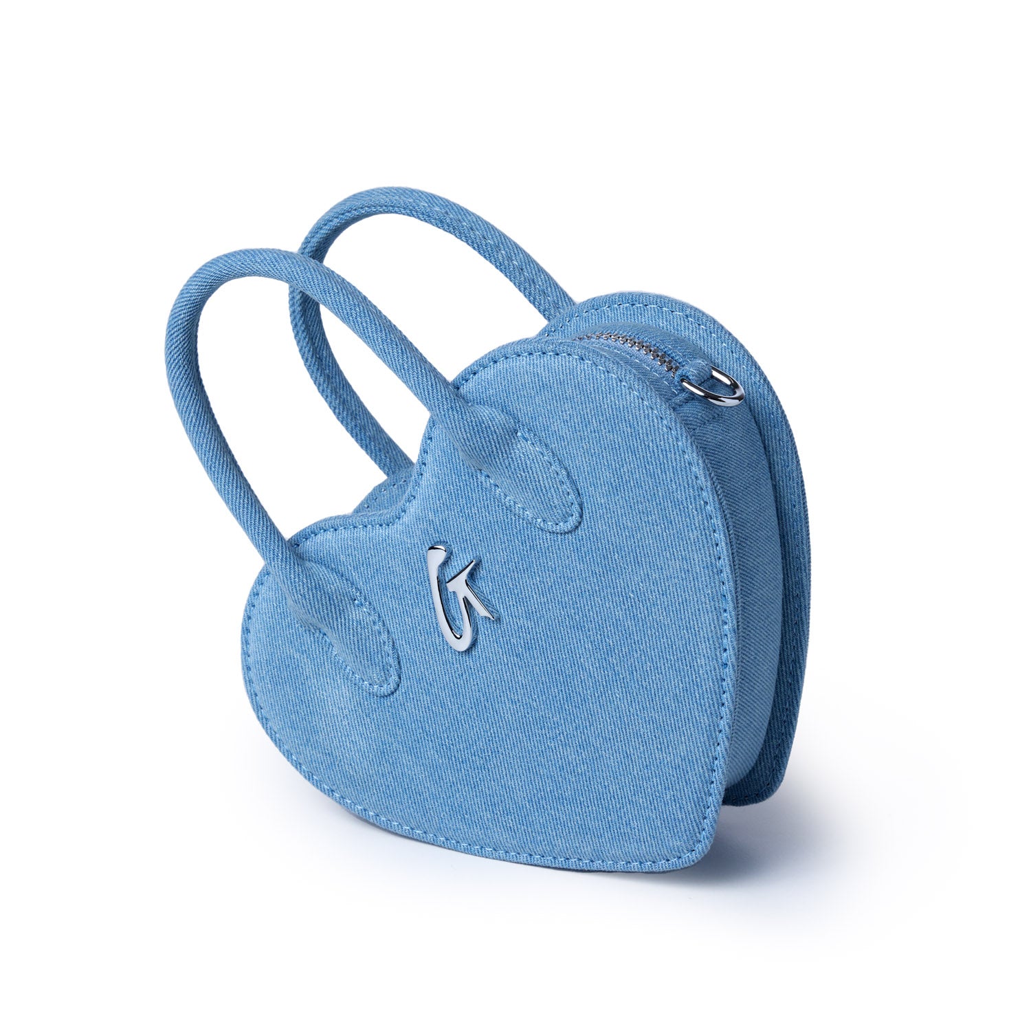 Mini denim heart-shaped bag with double straps, silver zipper, and a small metallic logo on the front.