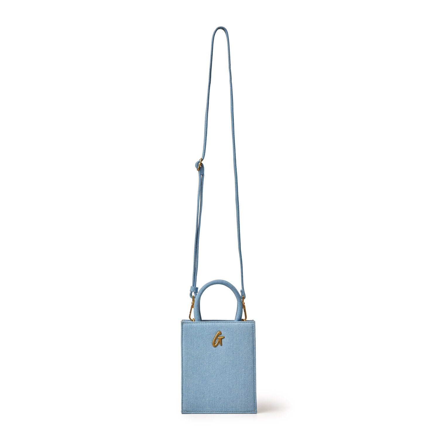 Mini denim gold tote bag with a rectangular shape, top handle, and adjustable shoulder strap featuring gold hardware.