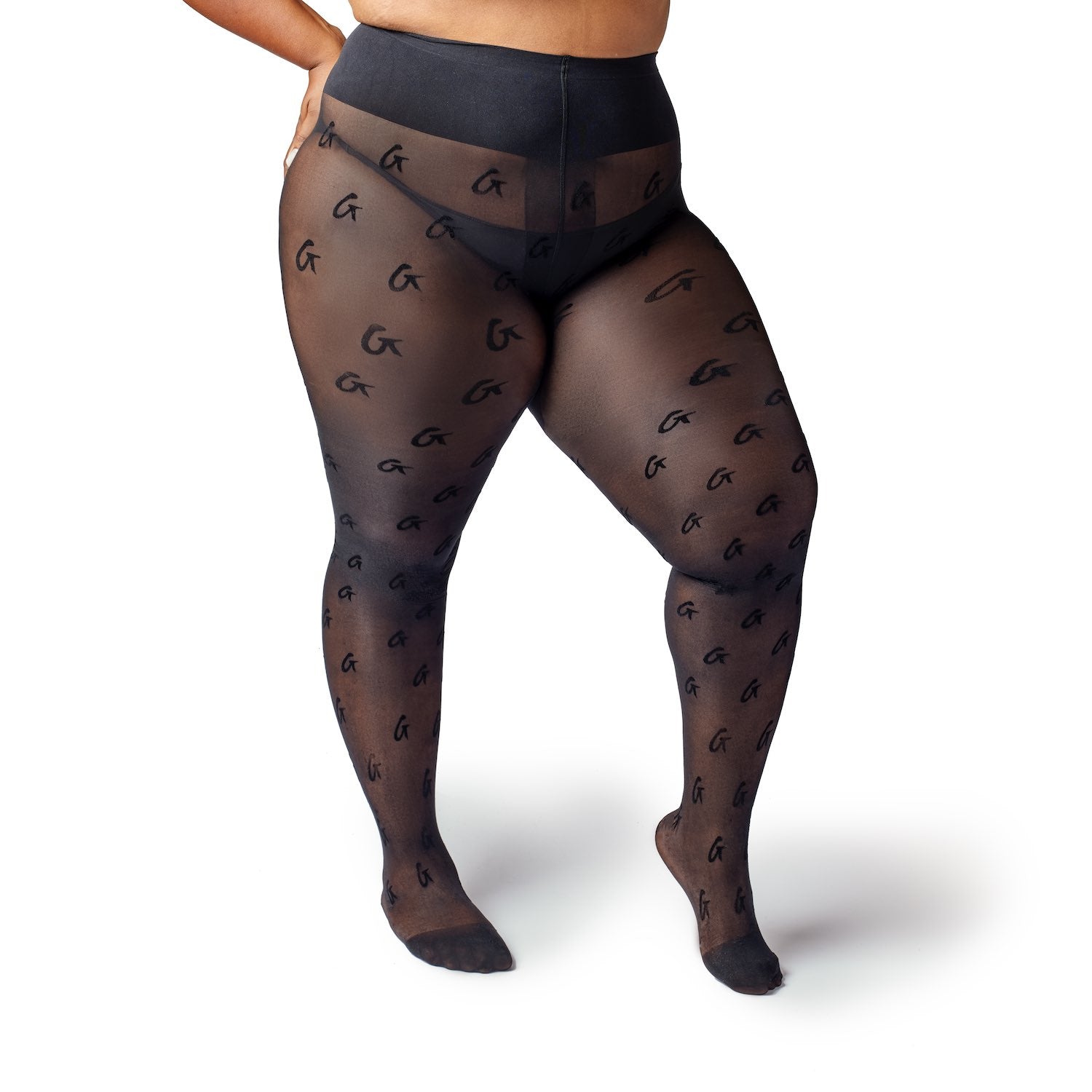 Sheer black logo stockings with a transparent finish and repeating logo pattern, worn by a model with black shorts.