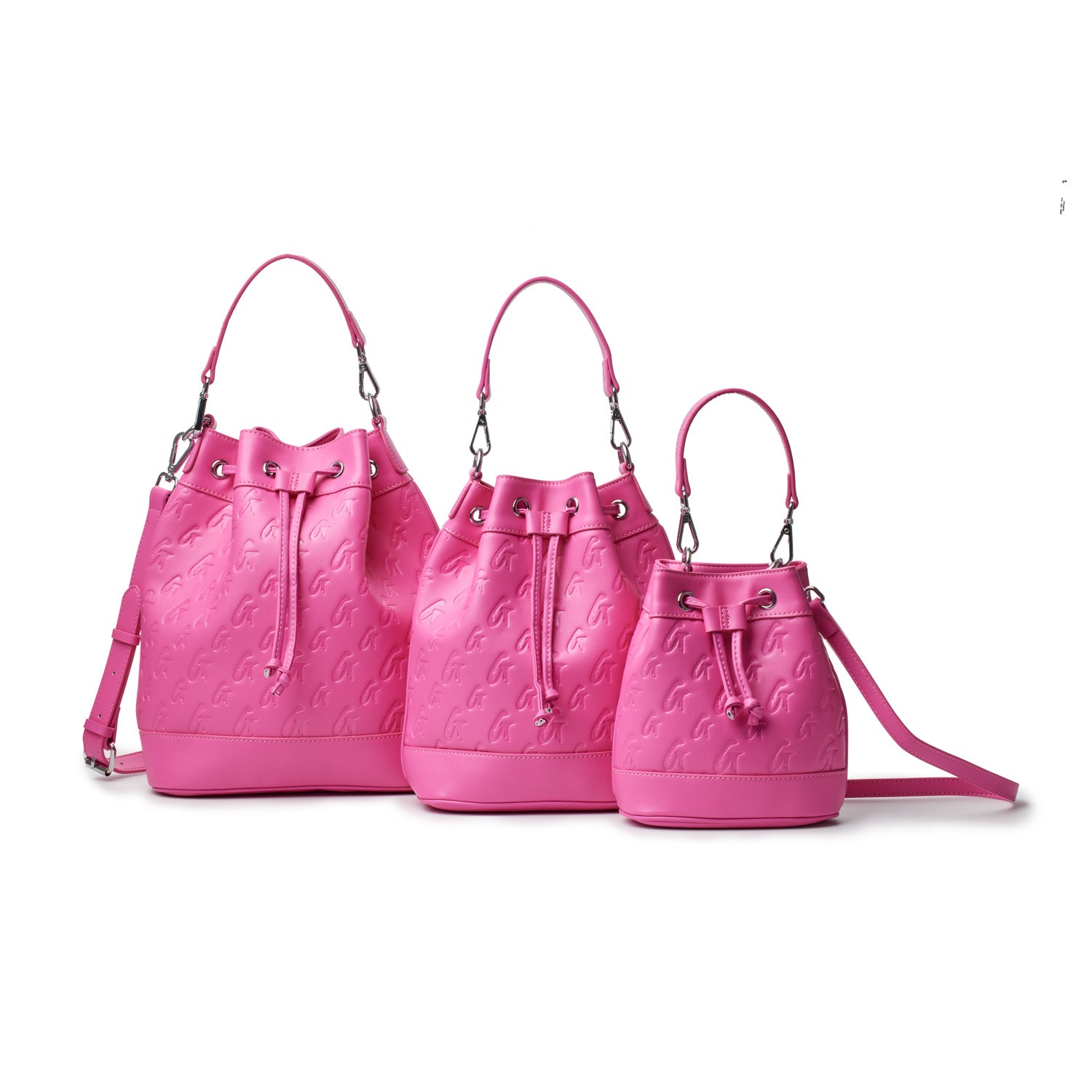 Three large, hot pink bucket bags with monogram pattern, drawstring closure, and adjustable straps, displayed against a white background.
