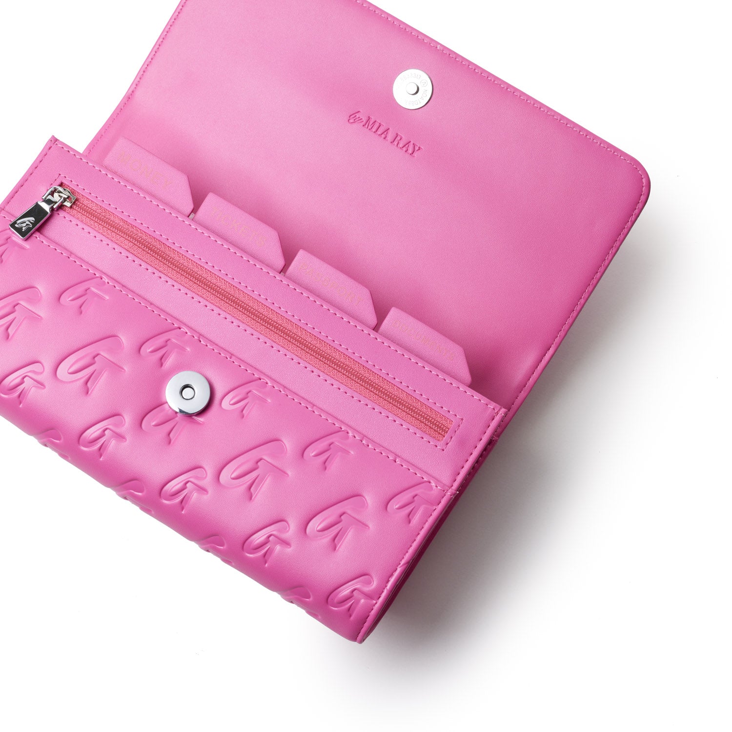 Open pink travel wallet with embossed arrow pattern, zipper pocket, card slots, and "MIA RAY" branding inside.