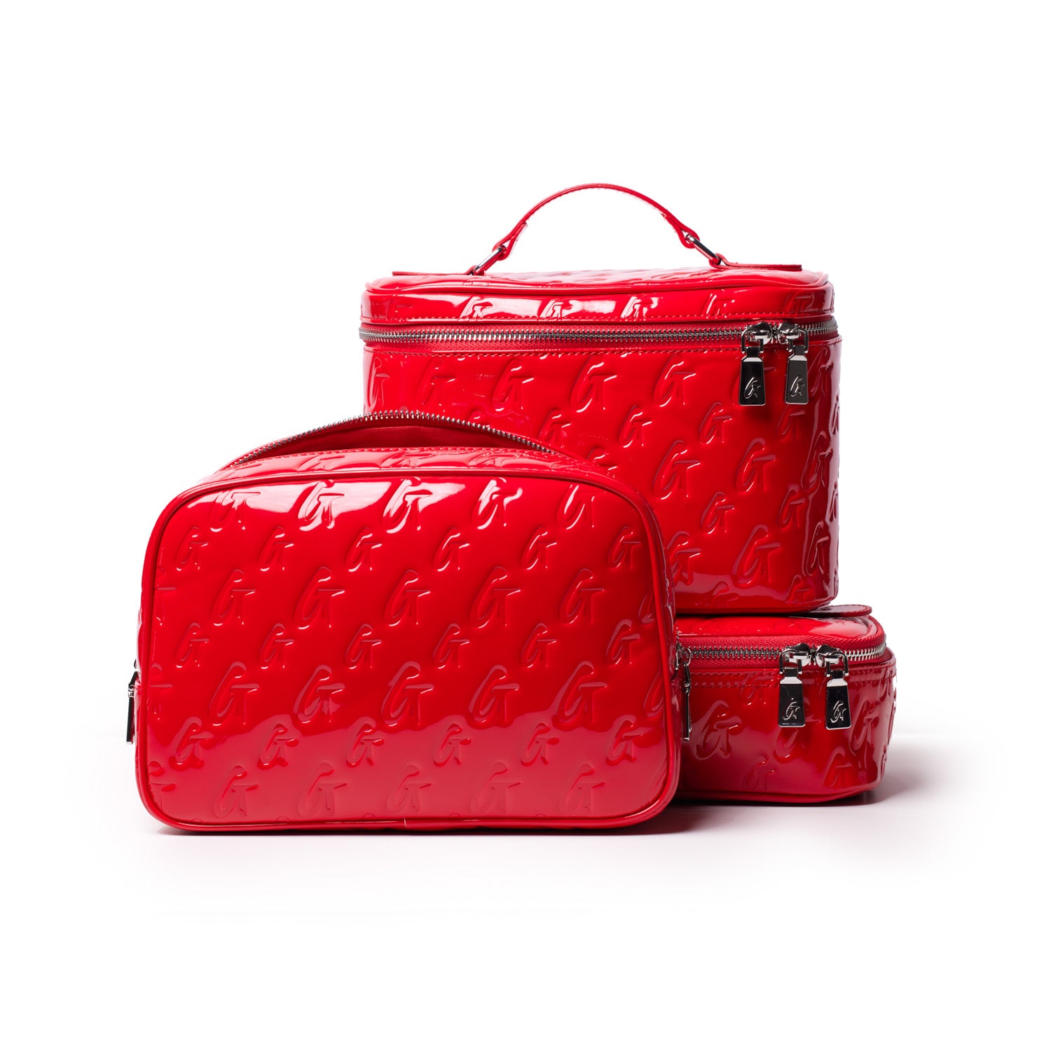 Red glossy monogram toiletry bag set with embossed "G" pattern, including a large, medium, and small bag with zippers.