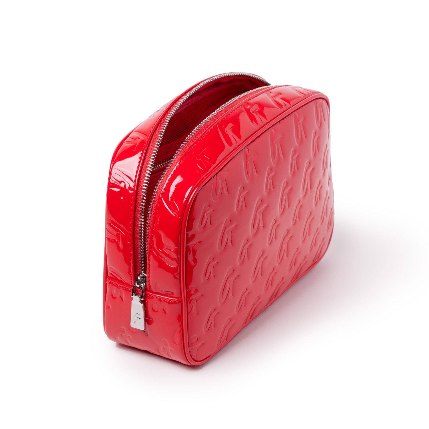Red glossy toiletry bag with embossed monogram pattern, silver zipper, and mirror detail, designed for travel accessories.