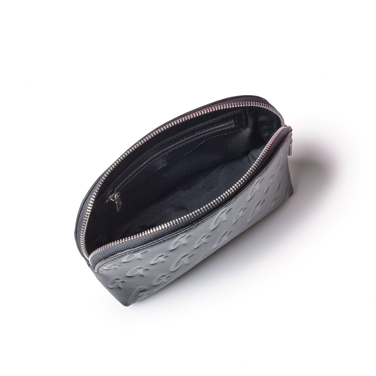 Black Monogram Cosmetic Pouch with embossed logo pattern, open to show interior with zip pocket and black lining.