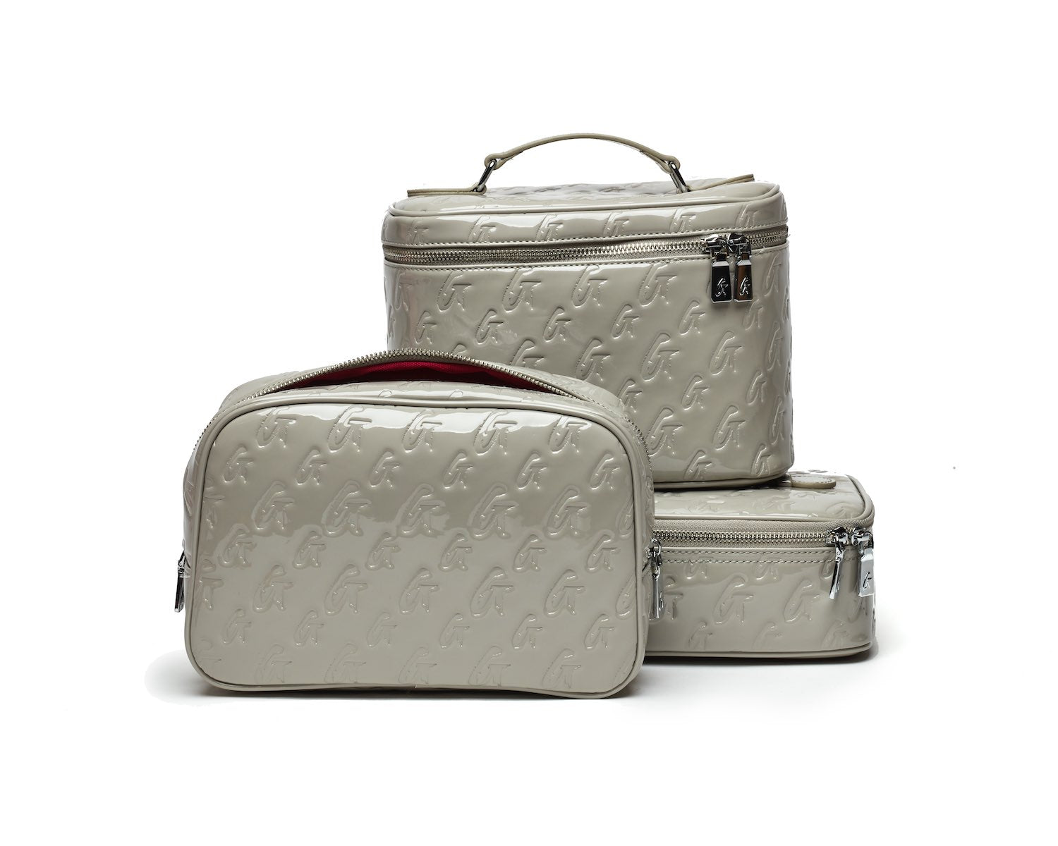 Large monogram toiletry bags in mirror gray with embossed logo pattern, zippers, and top handle, ideal for travel organization.