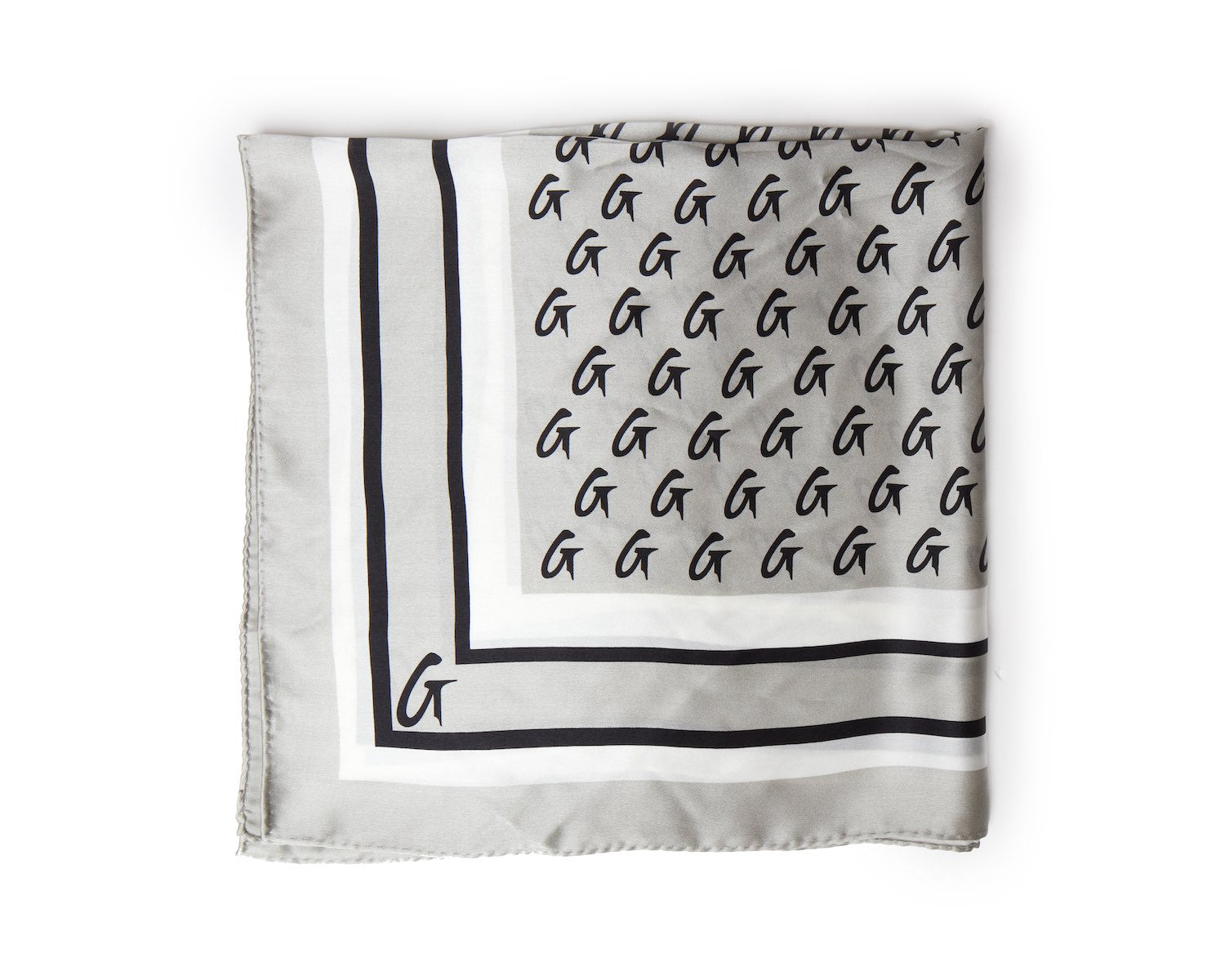 Medium silver silk scarf with a monogram pattern and border design, featuring black "G" initials.