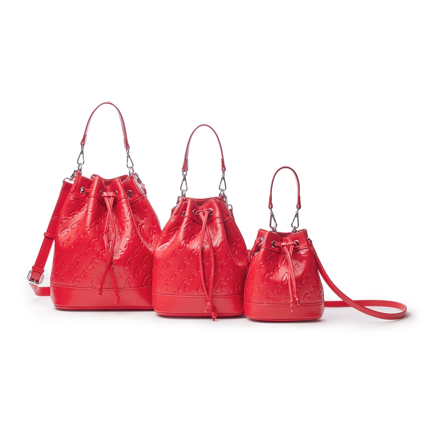 Medium red bucket bags with monogram embossed pattern, drawstring closure, and adjustable straps, displayed in three sizes.