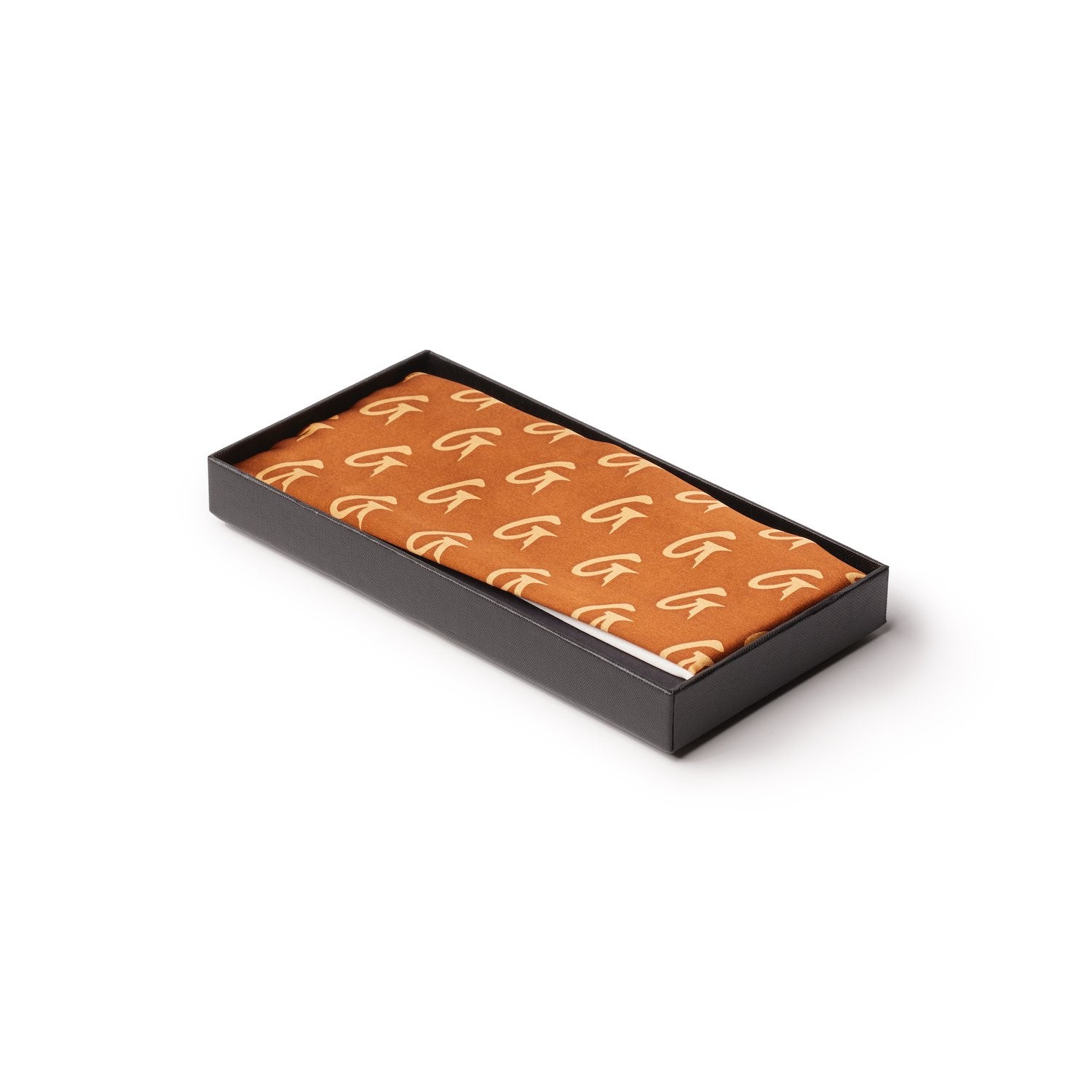 Large brown silk scarf with a monogram pattern, neatly folded inside a black presentation box.