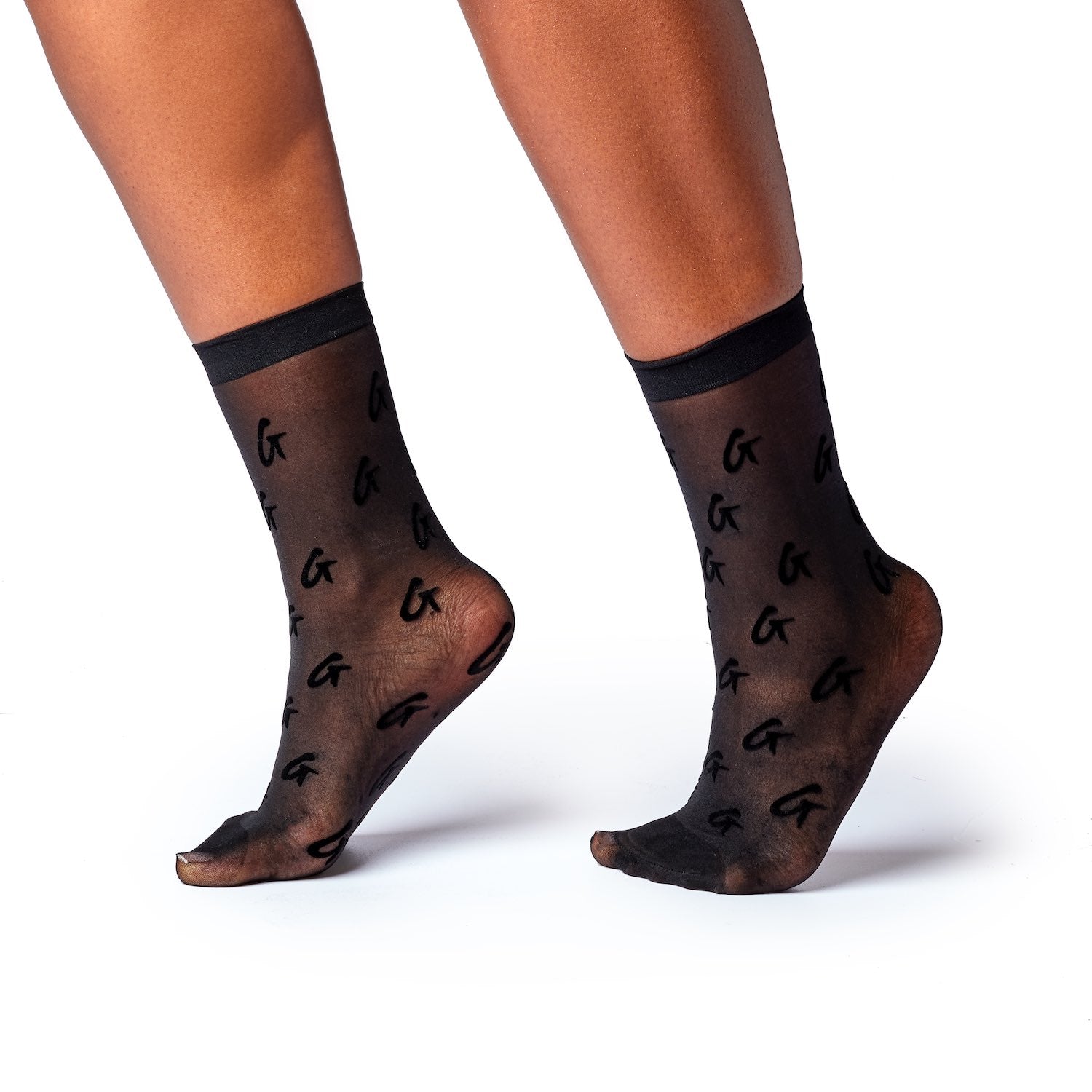 Black sheer socks with a logo pattern, featuring a transparent design and a solid black band at the top.
